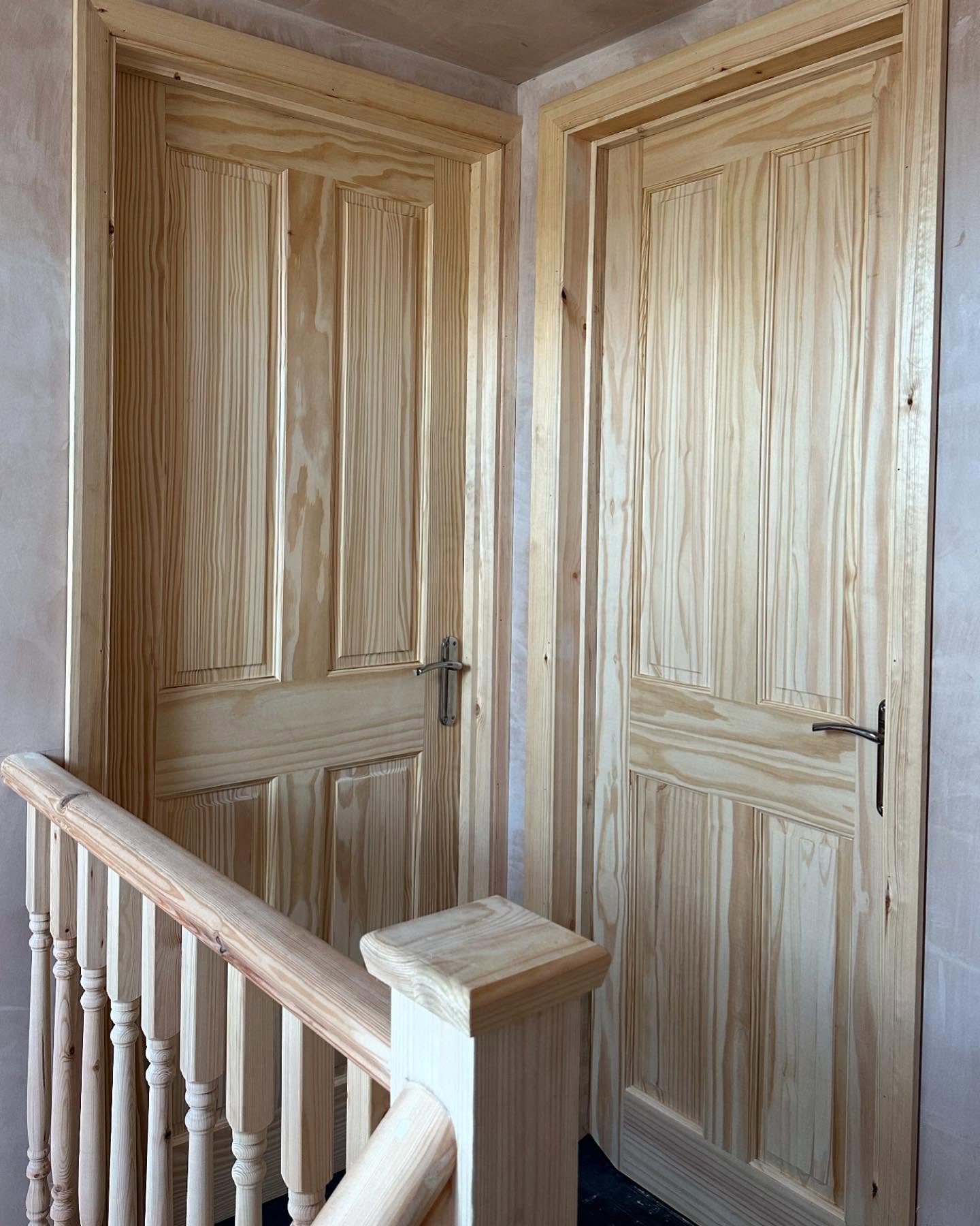Pine panelled doors and matching staircase balustrade
